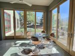 The sun porch with fully adjustable automatic blinds, two sets of double french doors and screens to expand the indoor living space outside for relaxation or entertainment